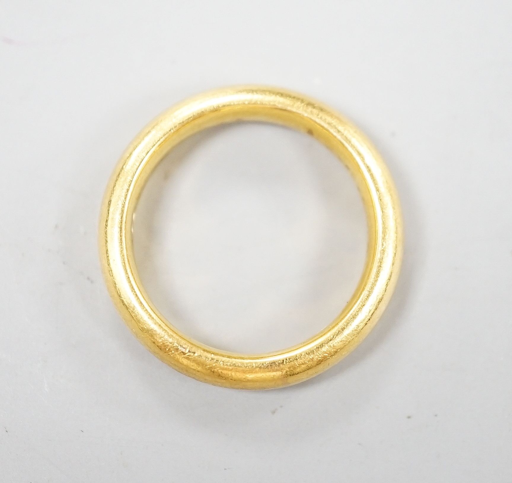 A 22ct gold wedding band, size K/L, 8.3 grams.